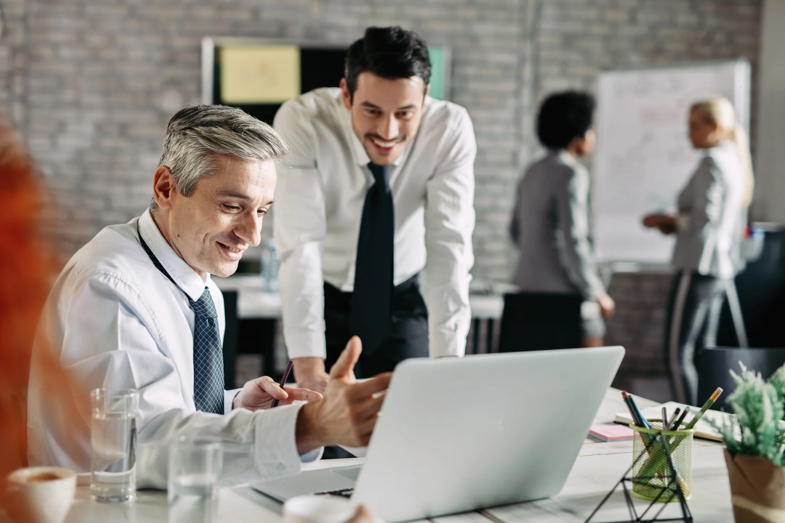two-happy-businessmen-reading-email-laptop-office-focus-is-mid-adult-businessman